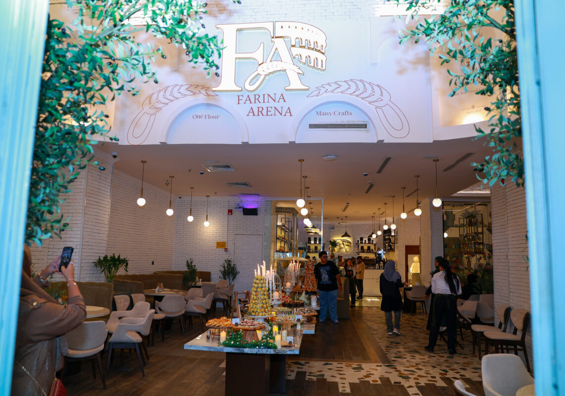 Farina Arena entrance with the FA emblem and a welcoming bakery table